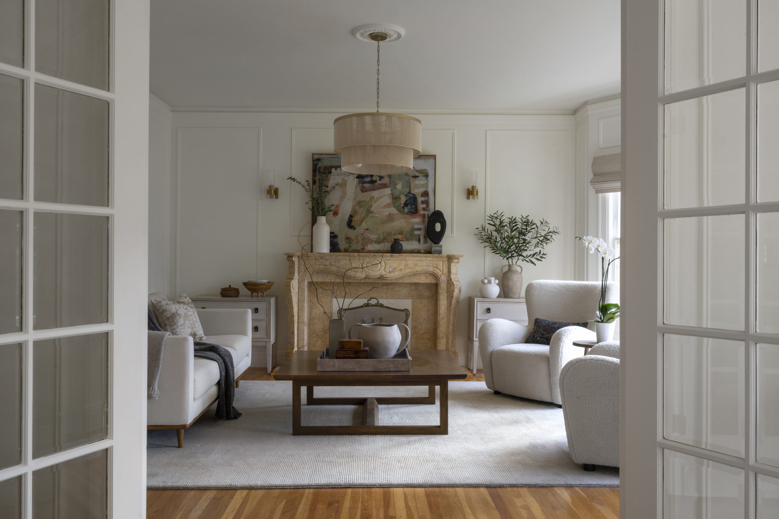 Living room with intricate moldings and large windows